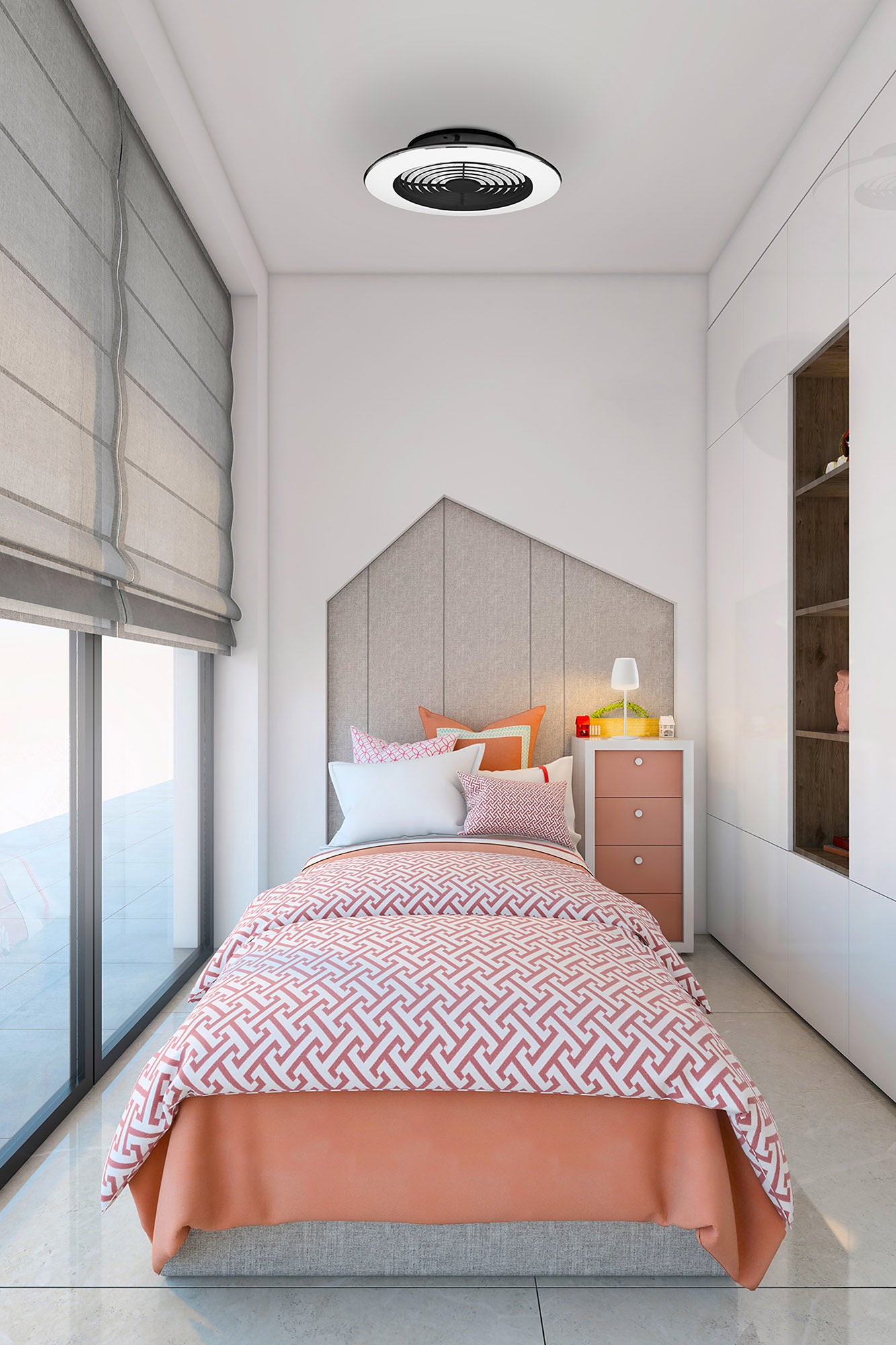 A modern bedroom with a single bed featuring a pink and white geometric pattern duvet and orange blanket. There's a padded headboard, a nightstand with a lamp and books, large windows with gray blinds, and an Alisio Mini Black Ceiling Fan with Light 52.5cm 70W LED Dimmable Ceiling Light With Built-In 30W DC Reversible Fan by Ceiling Fans UK above. The floor is tiled and the walls are white.